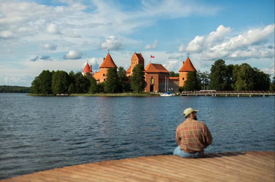 Jim's Saturday Tour from Vilnius to Trakai & Hill of Angels - The bus ride: Soviet-era blocks, Vilnius Old Town, and music